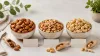 Almonds, peanuts and cashews in three labelled-by-shape unbranded bowls for a snack comparison