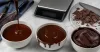 Three bowls showing pourable, drip and thick chocolate ganache consistencies