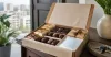 Chocolate gift box with warm decorative lights and no religious symbols