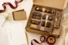 Open unbranded chocolate gift box with assorted formats and planning cards