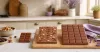 Unbranded chocolate bars, wafer pieces and wrapped candy arranged for a Cadbury format guide