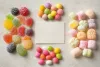 Unbranded jelly pieces, chewy dragees and marshmallows grouped around a blank ingredient card