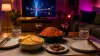 K-drama watch party snack table with spicy noodles, neutral crisps, sweets and cold drinks