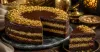 Cut kunafa chocolate cake showing cocoa, pistachio and crisp kataifi layers