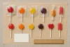 Unbranded wrapped lollipops in several shapes beside a blank count card and ruler