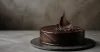Minimal dark chocolate cake with asymmetrical ganache texture and one chocolate shard