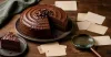 Chocolate cake with a missing slice, magnifying glass and blank clue cards