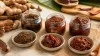 Unbranded glass jars of tamarind pickle showing sweet, sour and spicy texture variations
